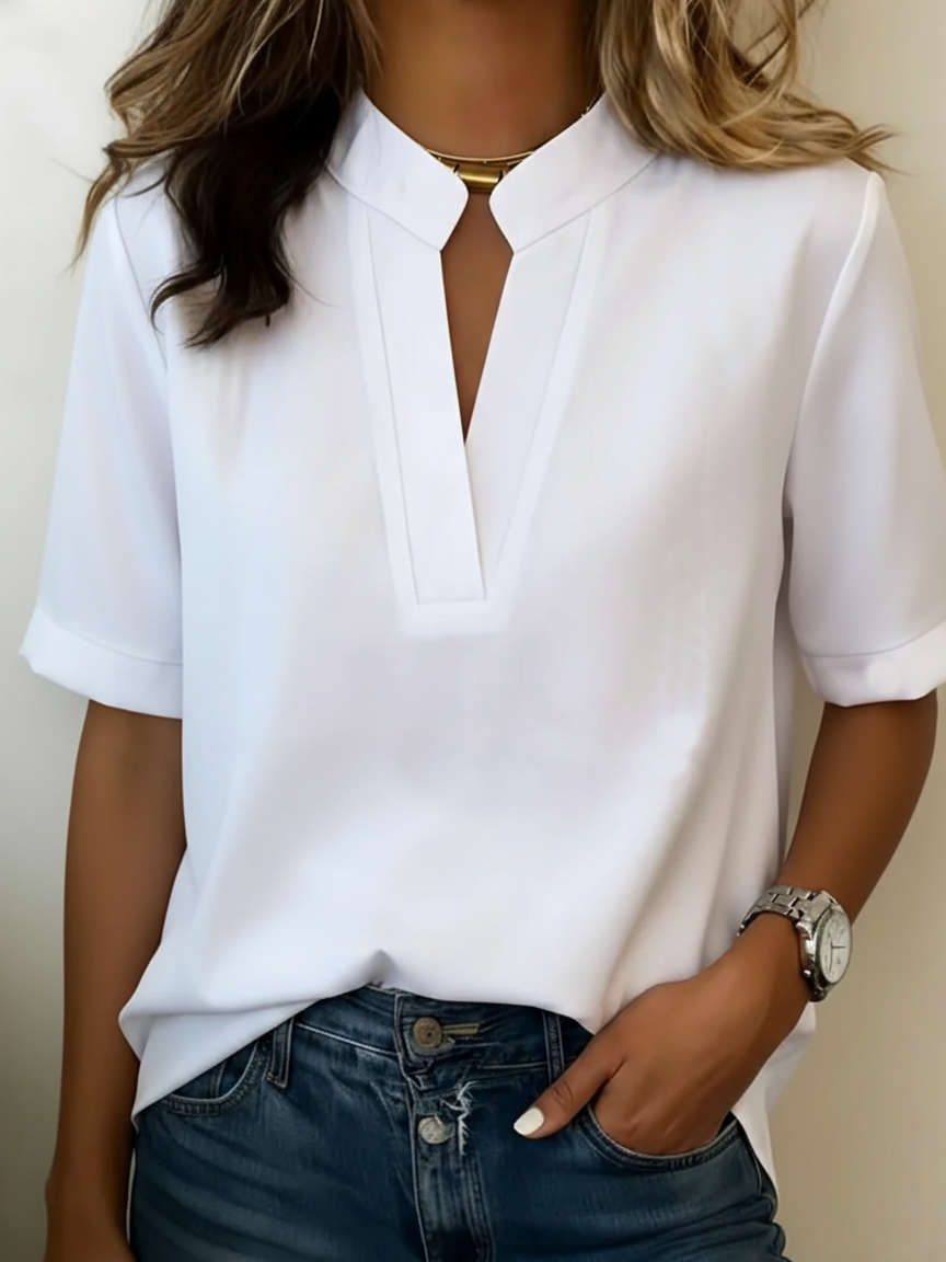 Woman in an elegant V-neck blouse with gold detail