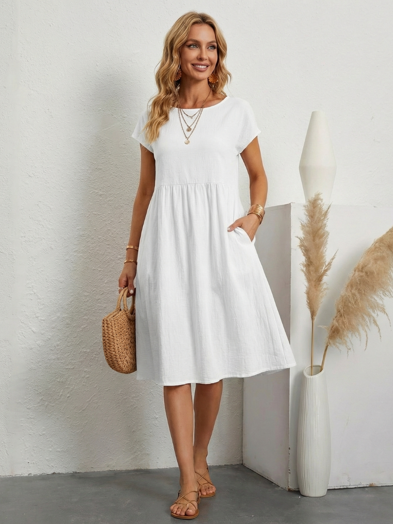 Woman in a relaxed linen and cotton dress with lace